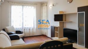 A television and/or entertainment centre at Sea View Rental Front Beach