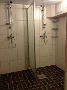 a shower with a glass door in a bathroom at Hiiumaa Ametikooli Accommodation in Suuremõisa
