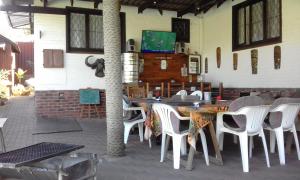 a group of tables and chairs in a restaurant at Smiths Cottage in Durban