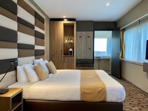 
a hotel room with a large bed and a large window at XO Hotels Blue Tower in Amsterdam
