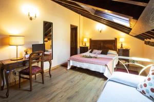 a bedroom with a bed and a desk and a bed sidx sidx sidx at La Casona de Tresgrandas in Tresgrandas