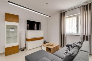 a living room with a couch and a table at Green Apartments Katowice Chorzów in Chorzów