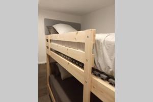 a wooden bunk bed in a small room at M2 Cool apartment next to metro. 15m to center in Esplugues de Llobregat