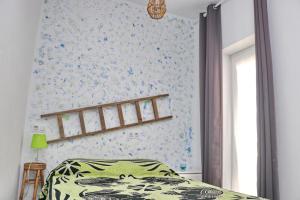 1 dormitorio con cama y pared de flores en Habitación Cañaveral Playa Conil I, en Conil de la Frontera