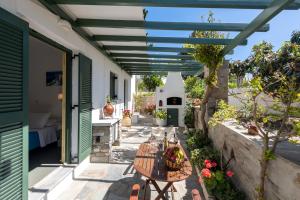 an outdoor patio with a table and awning at Margarita Studios in Parikia