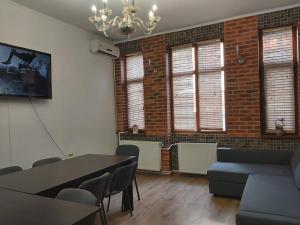 a room with a table and chairs and a brick wall at Villa Dumbrava Rosie in Constanţa