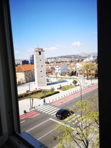 a view from a window of a street with a building at Clock Tower Apartments in Podgorica