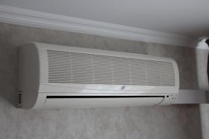 a white air conditioner hanging on a wall at Cosmos Business-Hotel in Kurgan