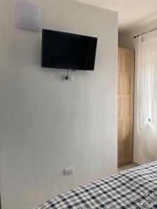 a bedroom with a bed with a flat screen tv on the wall at VISTAMARE VILLAGE in Silvi Marina