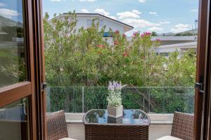 a balcony with a table and chairs and a view of a building at Hotel Ristorante La Conchiglia in Cala Gonone