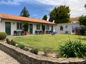 a house with a garden in front of it at Apartamentos Vale Da Varzea in Areia Branca