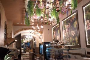 Odos Oneiron Boutique Hotel في مدينة خانيا: مطعم فيه ثريات و لوحات على الجدران