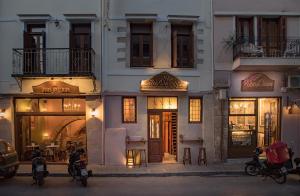 a group of motorcycles parked in front of a building at Odos Oneiron Boutique Hotel in Chania