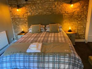a bedroom with a bed with two towels on it at Bear Inn in Bisley