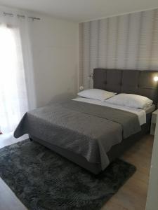 a bedroom with a large bed in a room at Apartments Lanterna Ražanac in Ražanac