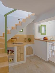 a kitchen with a staircase in a house at Elia Traditional suites in Astypalaia Town