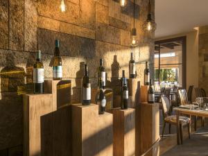 a bunch of bottles of wine on display in a restaurant at Hotel Fuerte El Rompido in El Rompido