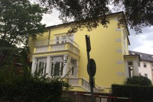 un edificio giallo con balcone sul lato di Ankerplatz Neumünster a Neumünster