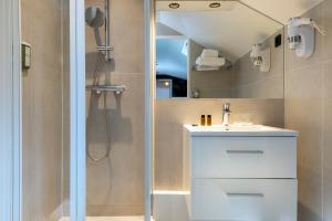 a bathroom with a white sink and a shower at Hotel Brady - Gare de l'Est in Paris