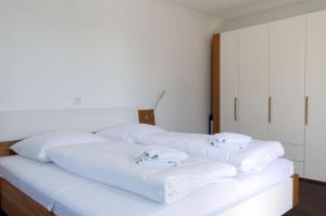 two beds in a room with white towels on them at Villa Insel in Börgerende-Rethwisch