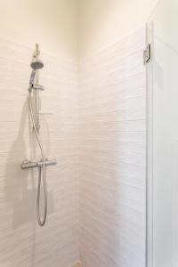 a shower with a shower head in a bathroom at Les Carmélites - Appartements dans l'hyper-centre de Rennes in Rennes