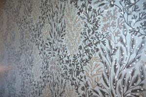 a curtain with a floral pattern on a wall at Hôtel Les Muses in Annecy