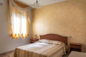 Postel nebo postele na pokoji v ubytování B&B La Mortella