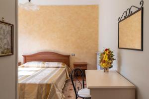 Postel nebo postele na pokoji v ubytování B&B La Mortella