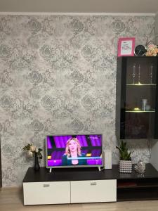 a tv sitting on a dresser in a living room at VP APARTMENTS in Sillamäe