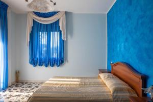 Postel nebo postele na pokoji v ubytování B&B La Mortella