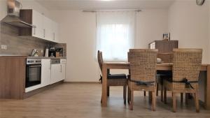 a kitchen with a table and chairs in a room at Ferienwohnung Sonnenschein in Burgau