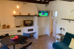 a living room with a table and a tv at Matteotti Loft in Volterra