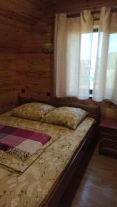 a bed sitting in a room with a window at Гостинний дім in Szack