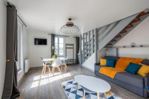 uma sala de estar com um sofá e uma mesa em El arco iris entre port et plage em Dieppe