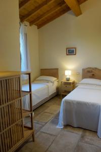 Postel nebo postele na pokoji v ubytování Agriturismo Cheloni