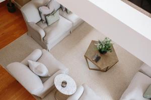 an overhead view of a living room with white furniture at The Scotsman Hotel in Edinburgh