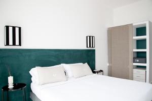 a bedroom with a large bed with a green headboard at Villa delle Palme in Santa Marinella
