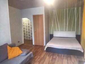 ノヴォクズネツクにあるAlways at home Apartments On Transportnaia 7のベッドルーム(ベッド1台、ソファ付)