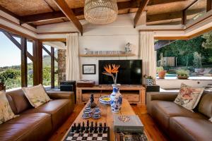a living room with leather couches and a chess board at Kinghorns Gardens in Cape Town