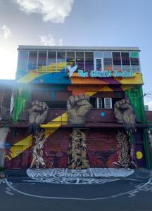 a building with a painting on the side of it at The GREEN Hostel in Pointe-à-Pitre