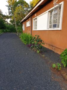 a driveway next to a house with a window at Captivating 3-Bed House in Moshi Town in Uru