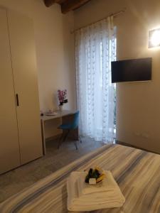 a room with a bed with a table and a desk at Corte Trento in Desenzano del Garda