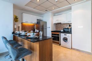 a kitchen with a counter and a dishwasher at The Smart Concierge - Bay Central in Dubai