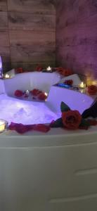 a white bed with roses on a table with lights at Canti apartments in Novi Sad +66 photos
