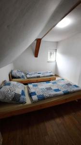 a room with two bunk beds in a attic at Dům u lesa - Nové Hamry in Nové Hamry