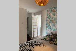 a bedroom with a bed with a leafy wall at chez LULU appartement neuf au coeur de cozzano in Cozzano