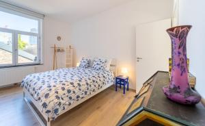 a bedroom with a bed and a vase on a table at Lyves Two in Liège