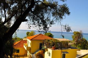 a house with a view of the ocean at Holiday House Angelos C on Agios Gordios Beach in Agios Gordios