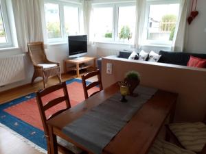 a living room with a table and a couch at Landhaus Barbara in Hippach