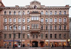 a large brick building on a city street at Nevsky 105 Hotel in Saint Petersburg